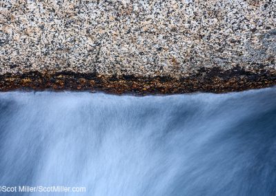 01462 Water rushing from beneath fractured granite rock in a High Sierra stream, CA